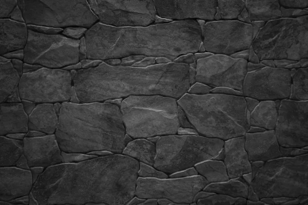 Чёрная каменная стена — стоковое фото