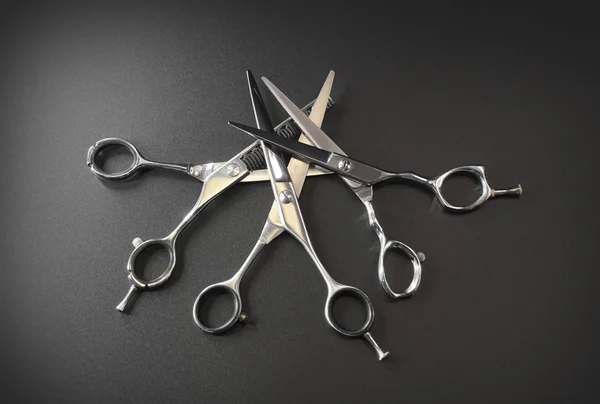 hairdressing different scissors isolated on black background.