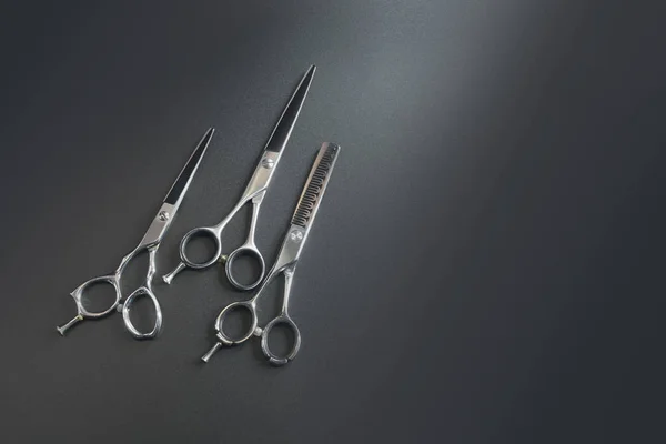 hairdressing different scissors isolated over  black background.