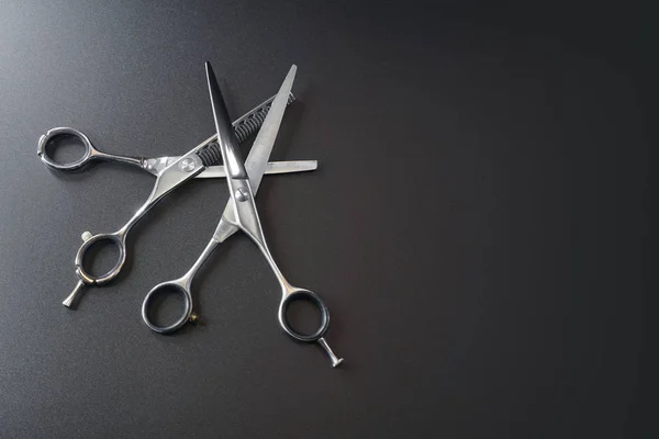 hairdressing different scissors isolated on black background
