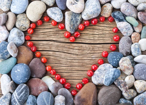Kalp sembol ahşap yüzeyde oluşturan taşlar