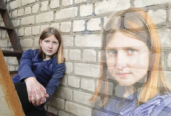 Portrait of a teenage girl near a brick wall, double exposure — Stock Photo, Image