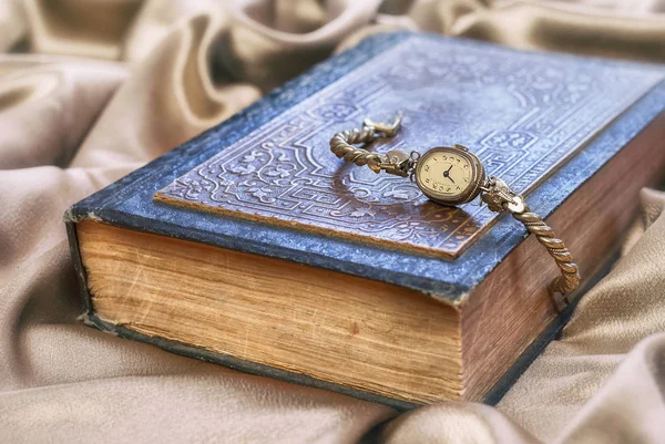 Vintage old clock lying on book . — Stock Photo, Image