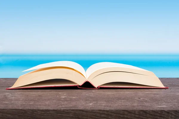 Tropical sea seen from the boat. Book on table. Reading and rela — Stock Photo, Image