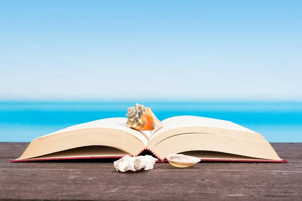 Tropical sea seen from the boat. Book on table. Reading and rela — Stock Photo, Image