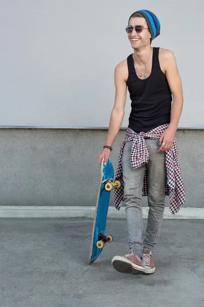 Man with skateboard on city street — Stock fotografie