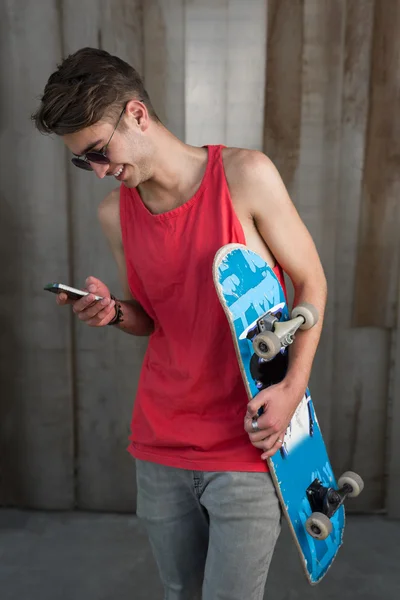 Tiener skater jongen met smartphone — Stockfoto