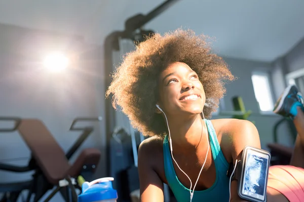 attractive afro american woman in sportswear enjoying time in gym