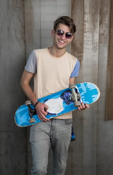 smiling man with skateboard