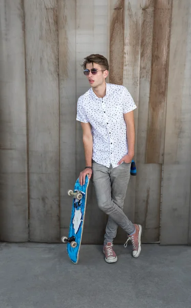 Jonge mode man met skateboard — Stockfoto