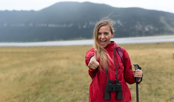 Woman with binoculars hiking in mountains — Stock Photo, Image