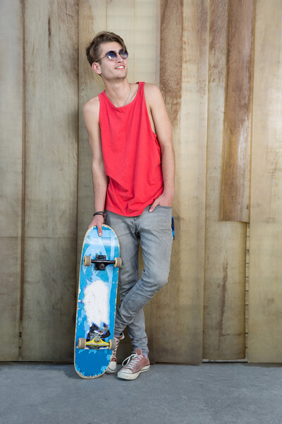 Young fashion guy with a skateboard