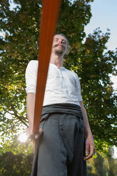 Man practising slack line in park