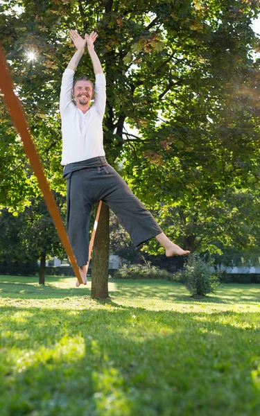 Man utövar slack linje i park — Stockfoto