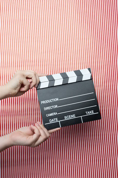 Woman holding movie clapper — Stock Photo, Image