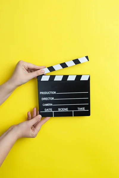 Woman holding movie clapper — Stock Photo, Image
