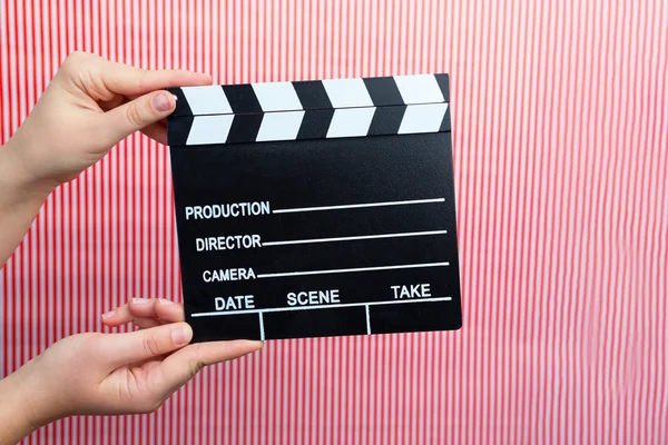 Woman holding movie clapper — Stock Photo, Image