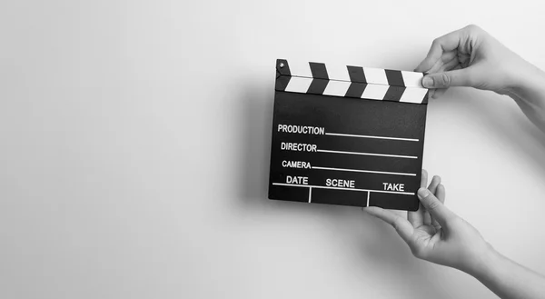 Woman holding movie clapper — Stock Photo, Image