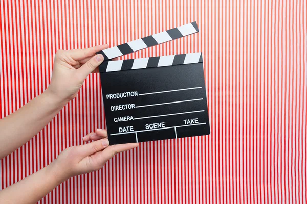 Woman holding movie clapper — Stock Photo, Image