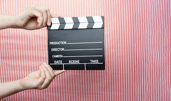 Woman holding movie clapper — Stock Photo, Image