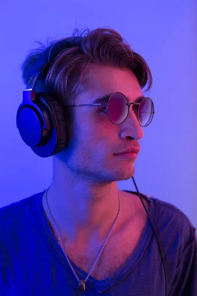 dj with headphones in nightclub