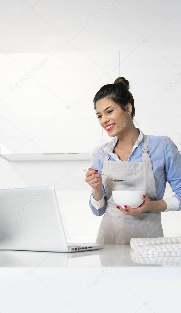 Woman having breakfast in kitchen