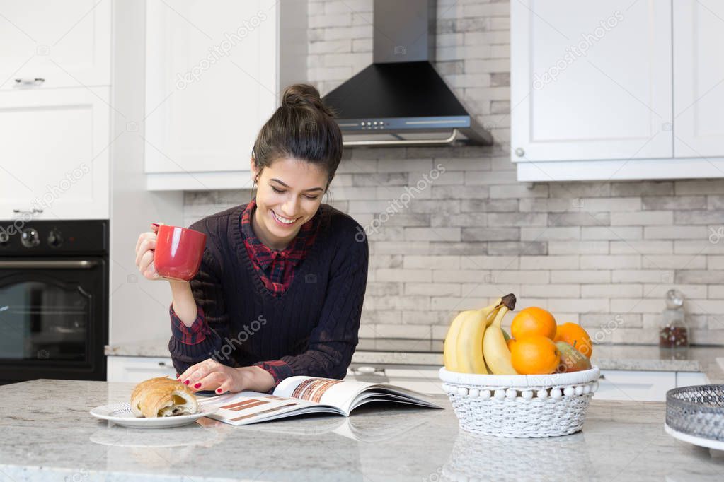 Woman having coffee in kitchen