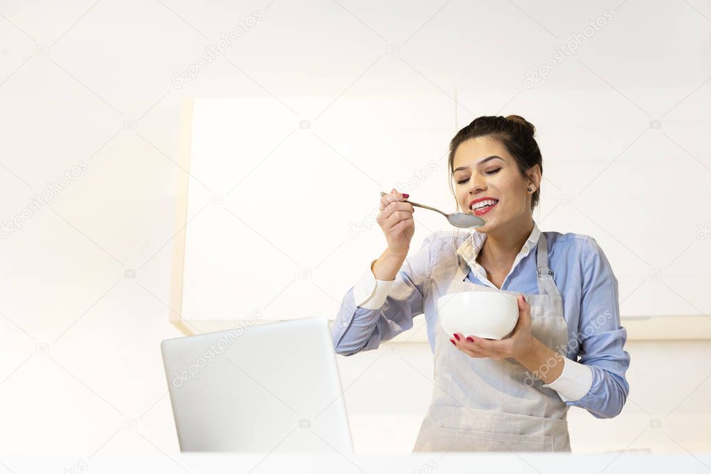 Woman having breakfast in kitchen