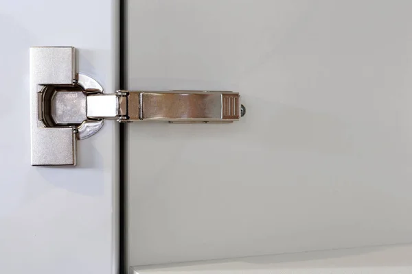 A modern door hinge, a closeup shot
