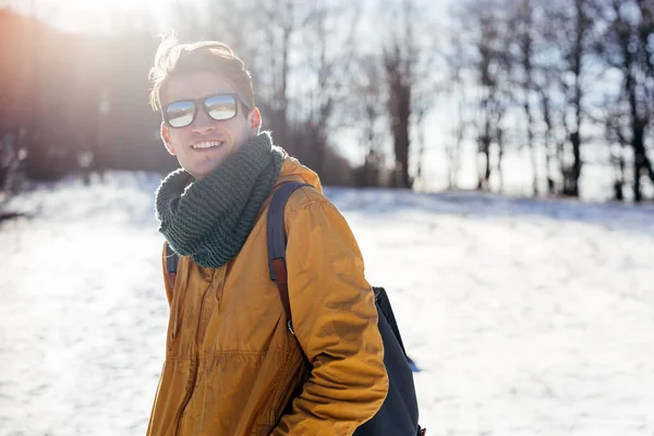 Genç adam kış ormanında