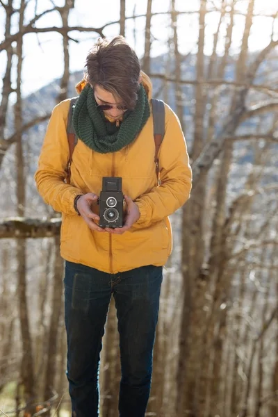 Uomo con fotocamera vintage nella foresta — Foto Stock