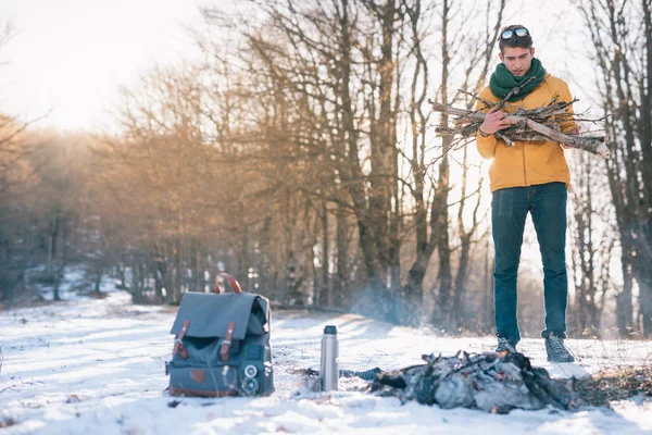 Genç adam kış ormanında