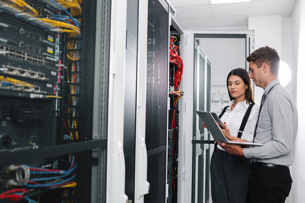 Team of technicians working together on servers at the data centre