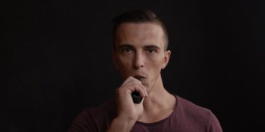 Erkekler siyah arka plan vaping ve Buhar bulutu serbest bırakır.