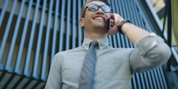 Young Man White Shirt Talking Mobile Phone Front Office Building — Stock Video