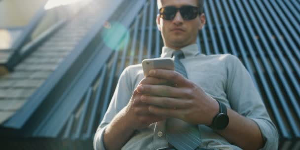 Young Man White Shirt Using Mobile Phone Front Office Building — Stock Video