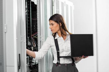 Sunucu odasına dizüstü bilgisayar ile bir sorunu gidermekle genç uzman tehnician