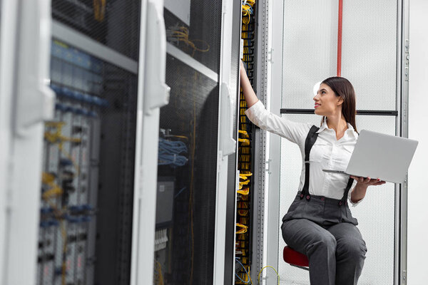 Technician analyzing server in server room