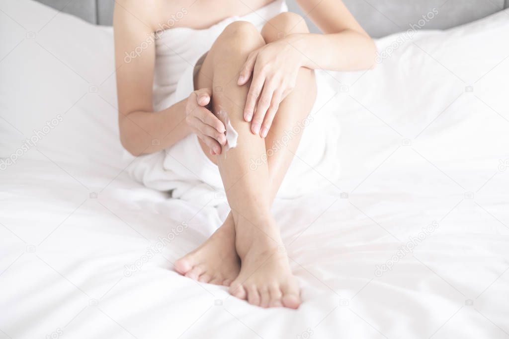 Woman applying legs cream,lotion , Hygiene skin body care concept