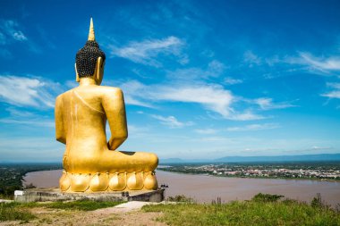 The Golden Buddha at Phu salao temple overlooking the Mekong river and the city of Pakse, Laos. clipart