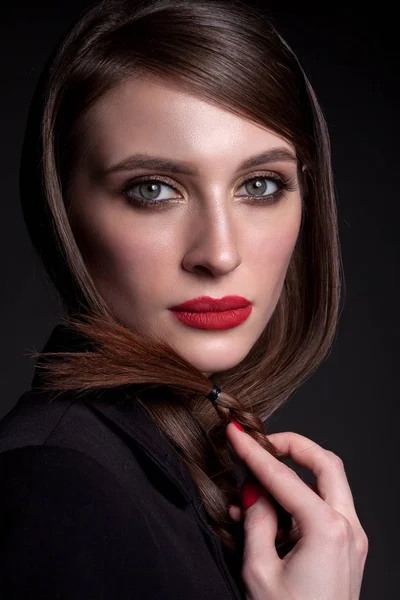 Portrait of a beautiful woman on a black background in a busines — Stock Photo, Image