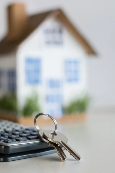 Mortgage concept focused on the coins and keys real estate property with loan money bank concept. — Stock Photo, Image