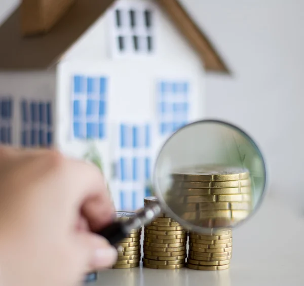 Mortgage concept focused on the magnifying glass — Stock Photo, Image