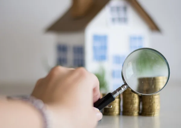 Mortgage concept focused on the magnifying glass — Stock Photo, Image