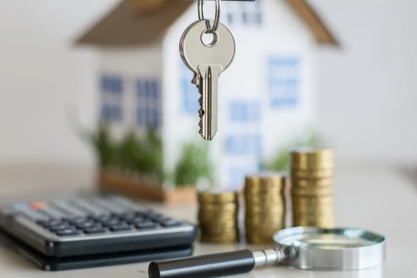 Mortgage concept focused on the coins and keys real estate property with loan money bank concept. — Stock Photo, Image