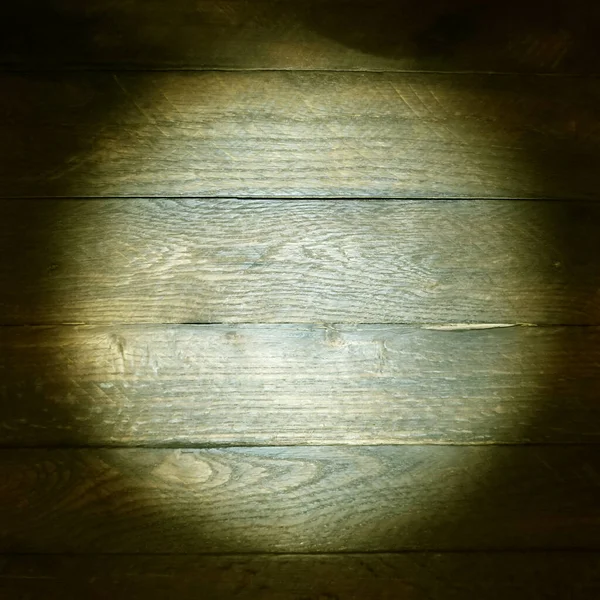 wooden texture.light on a dark surface.