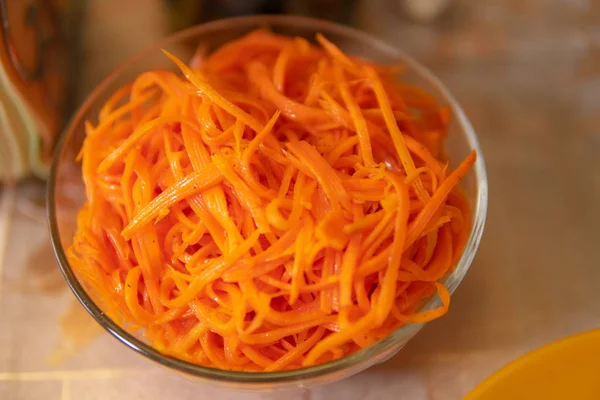 Korean carrot is on the kitchen table in a glass Cup