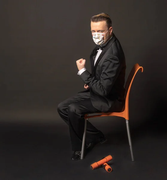 Coronovirus, a man in a mask on a black back. The outbreak has begun. Epidemic.