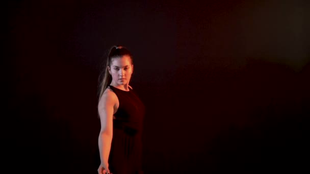 Girl on black background smiling and dancing ballroom dances, is happy — Stock Video