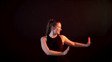 The forgotten modern movement, hip hop hands girl dancing on dark background